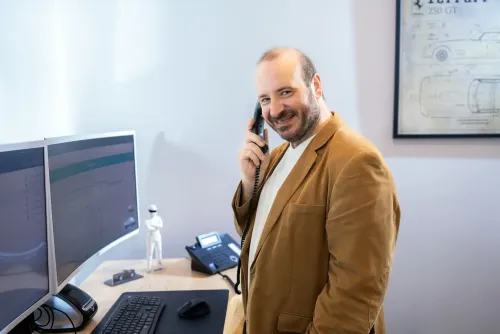 Phil Testa talking with a client on the phone.